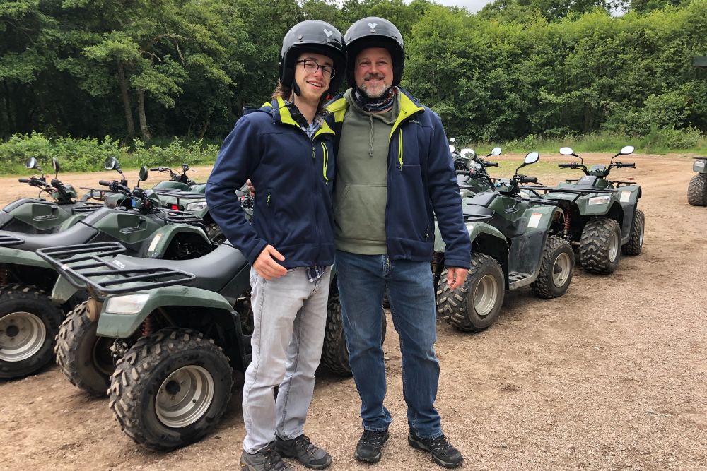Couple of men quad biking celebrating winning a road traffic accident legal claim